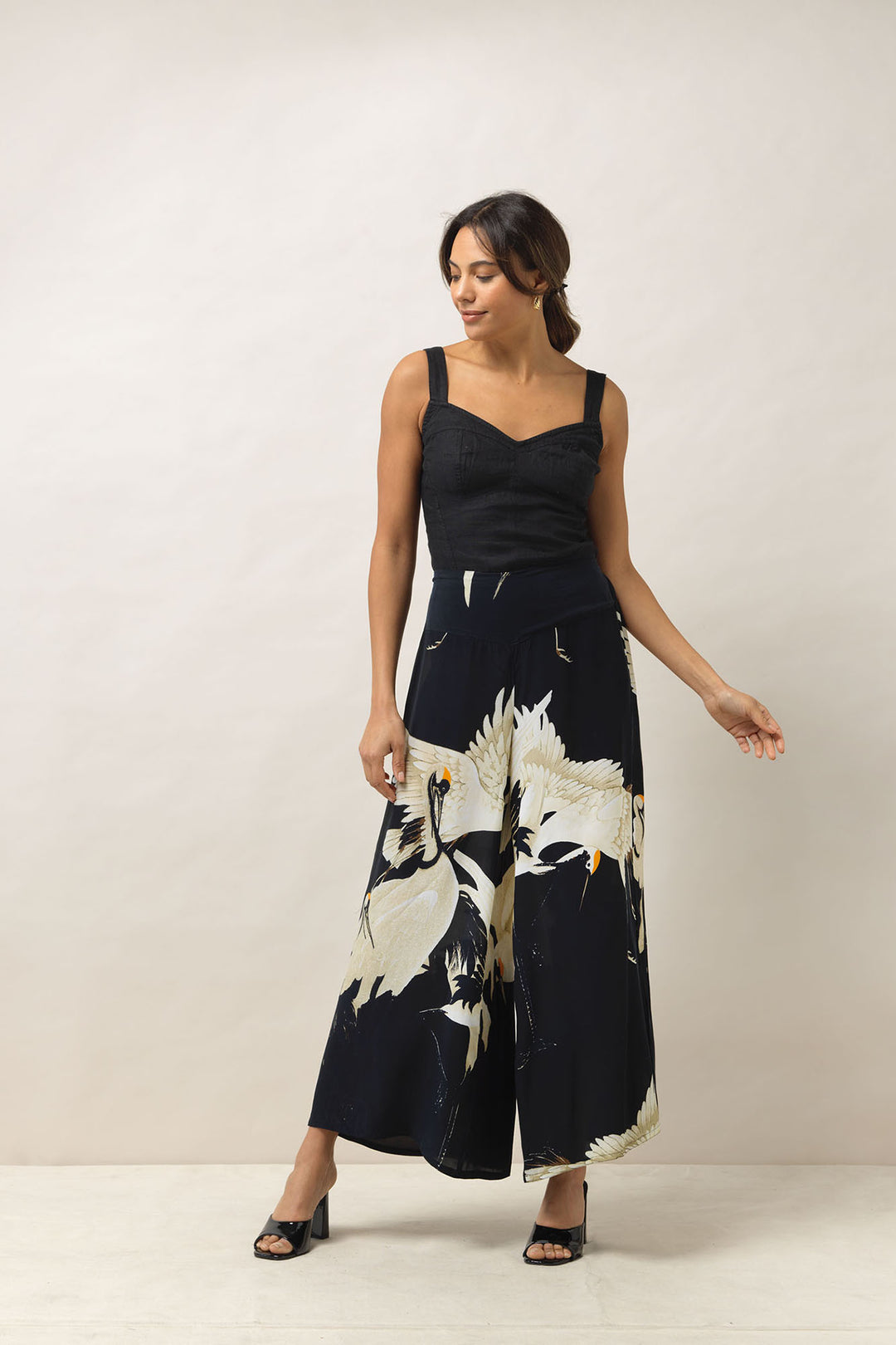 Ladies palazzo crepe pants black background with stork bird print by One Hundred Stars