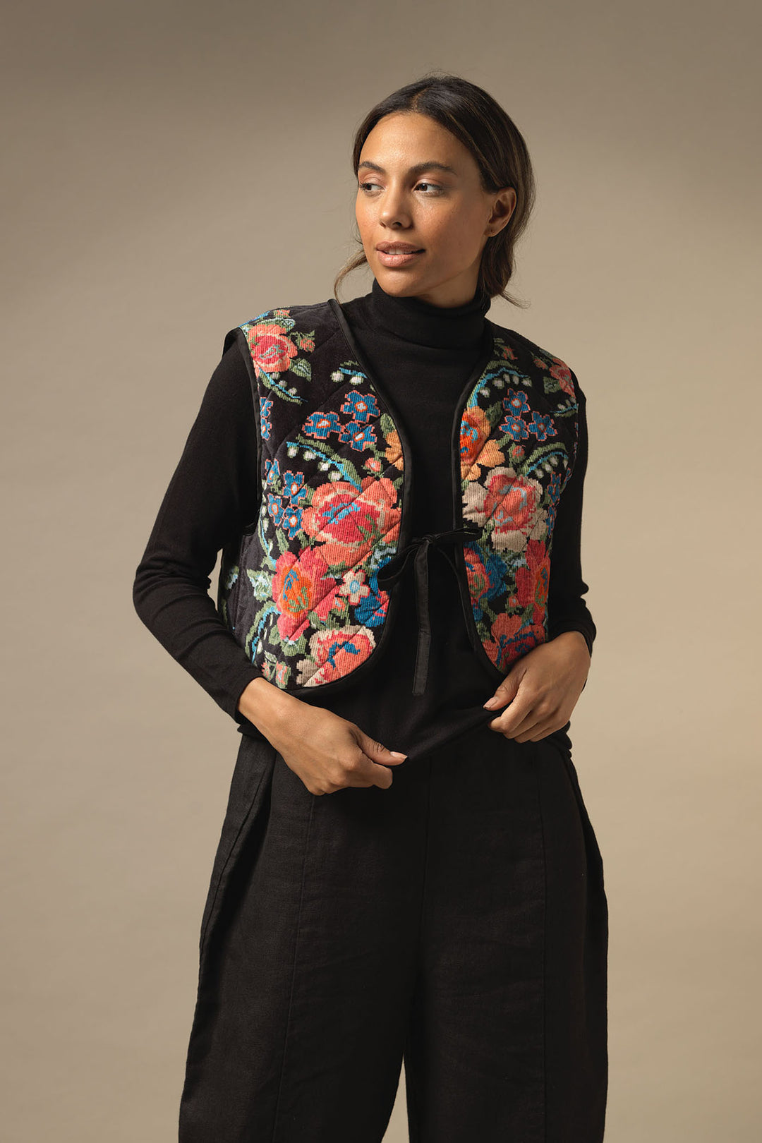 ladies velvet short gilet party in woven flower print featuring colourful flowers on a black background by One Hundred Stars