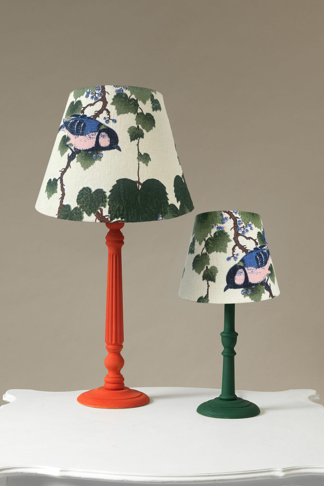 two sizes of autumn winter handmade lampshades with green maple leaf pattern on a cream background by One Hundred Stars