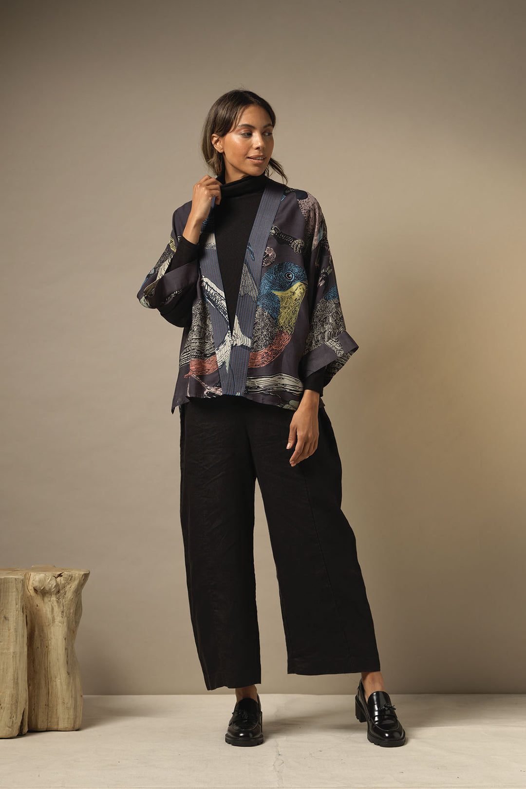 Ladies short kimono with a colourful bird print on a dark grey background by One Hundred Stars