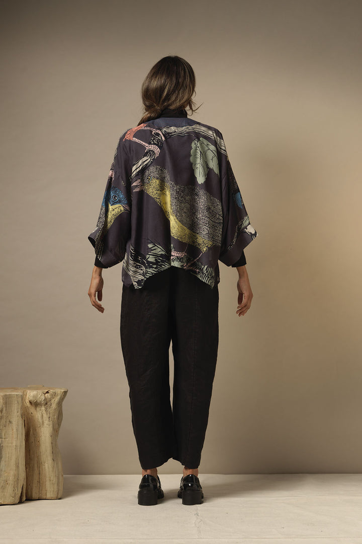 lightweight ladies short kimono jacket with a colourful bird print on a dark navy background by One Hundred Stars