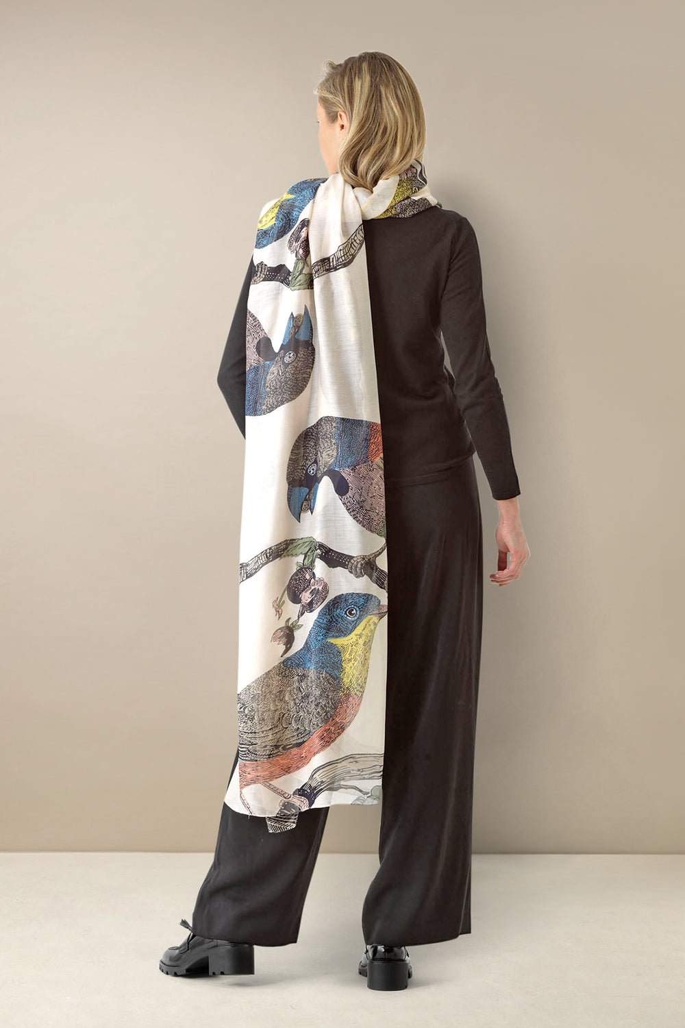 ladies winter scarf with a colourful bird print on a light stone background by One Hundred Stars