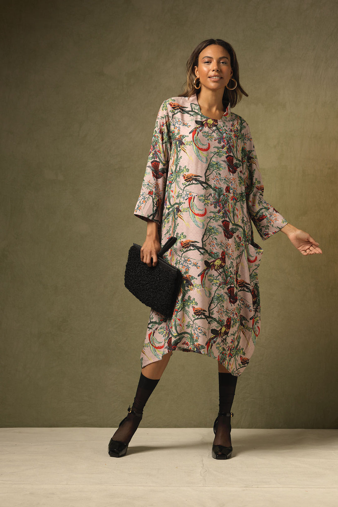 3/4 length sleeve asymmetric ladies dress with chinoiserie patterns on a dusky pink background by One Hundred Stars