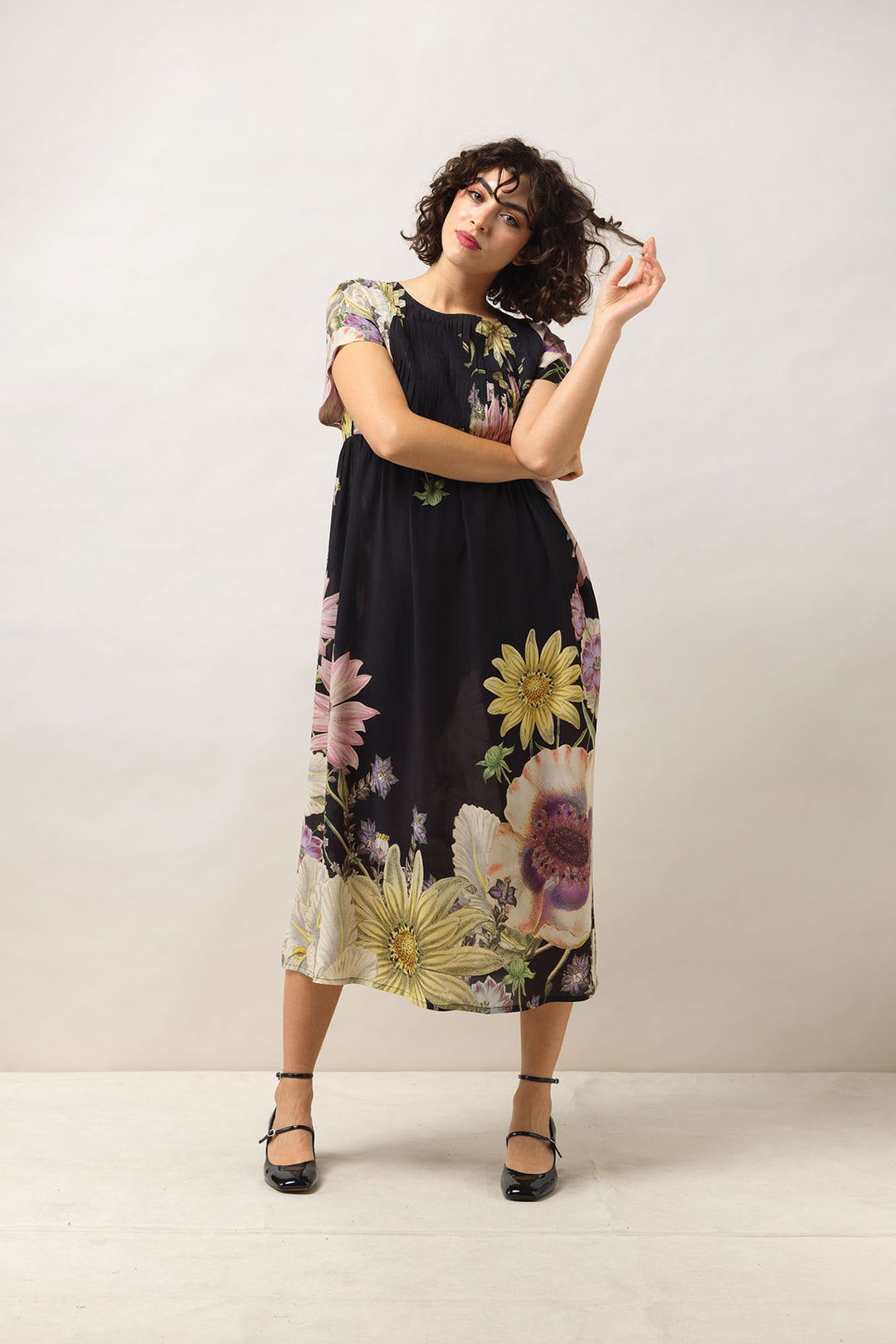 Women's short sleeve pleated dress in black with daisy floral print by One Hundred Stars