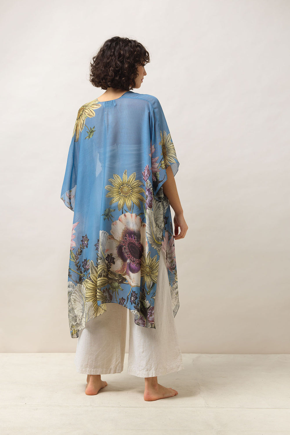 Women's lightweight throwover shawl in cornflower blue with daisy floral print by One Hundred Stars