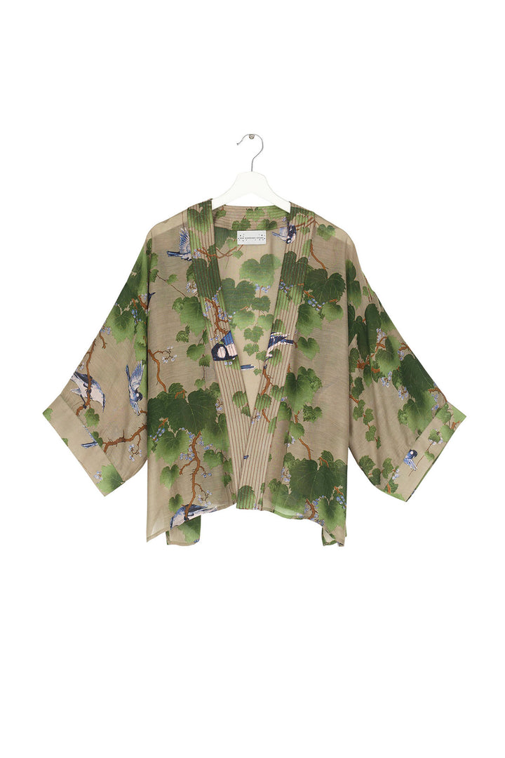 Short ladies kimono with green maple leafs on a stone background by One Hundred Stars