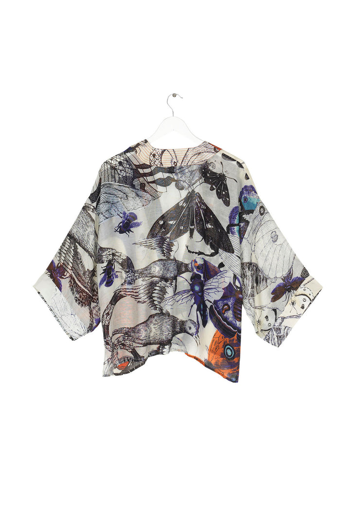 ladies open front short kimono jacket with a butterfly and insect print on a cream background by One Hundred Stars