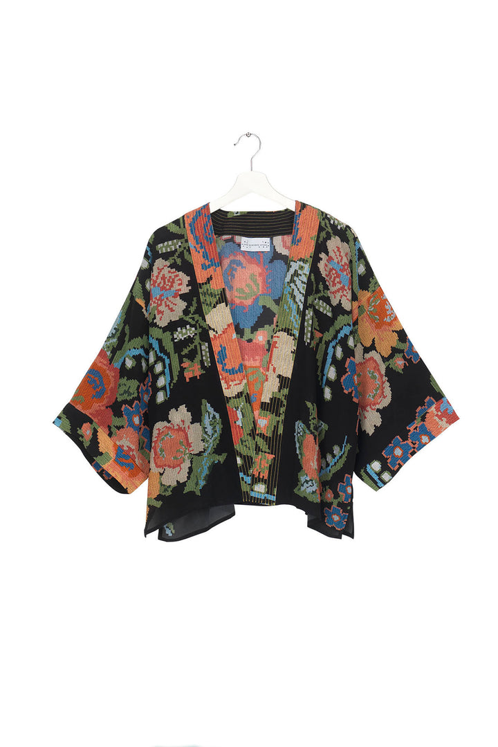 ladies short kimono jacket crepe in woven flower print featuring colourful flowers on a black background by One Hundred Stars