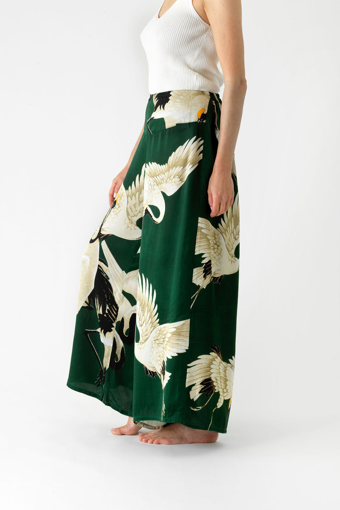 ladies satin palazzo pants green background with stork bird print by One Hundred Stars