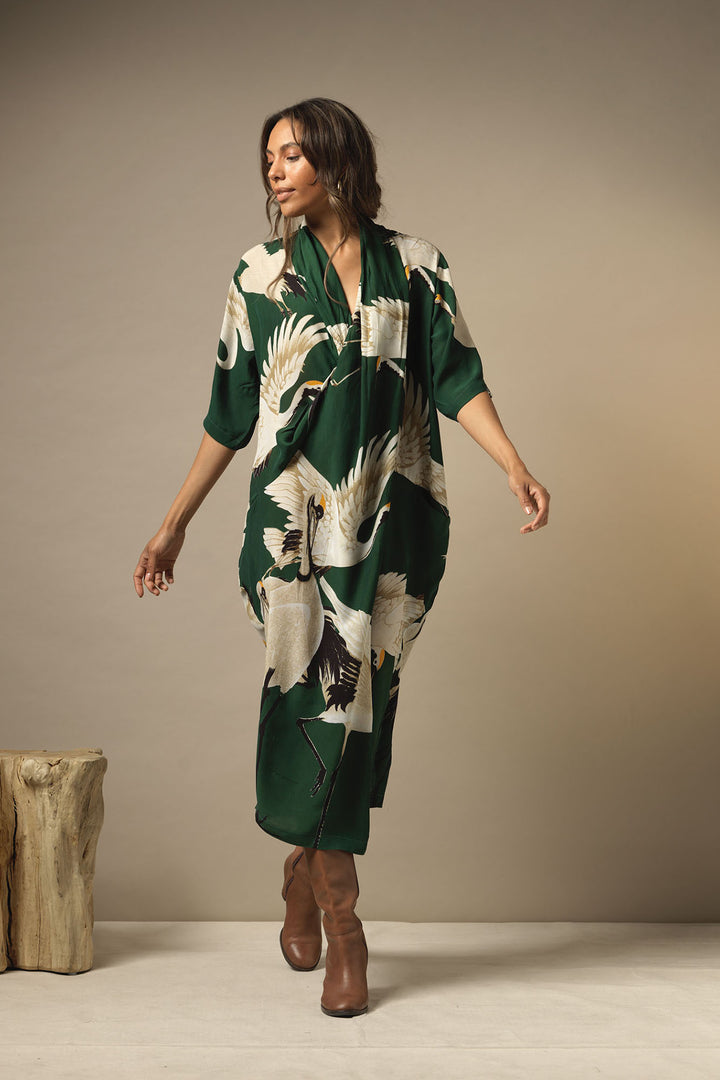 ladies long length pocket dress cowl neck winter green background with stork bird print by One Hundred Stars
