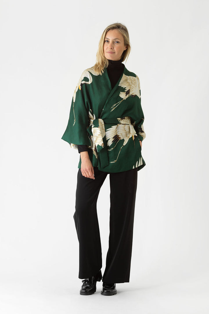 ladies satin wrap jacket green background with stork bird print by One Hundred Stars