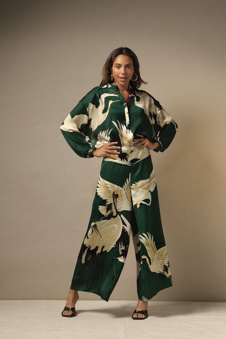 ladies satin matching set shirt and palazzo pants green background with stork bird print by One Hundred Stars