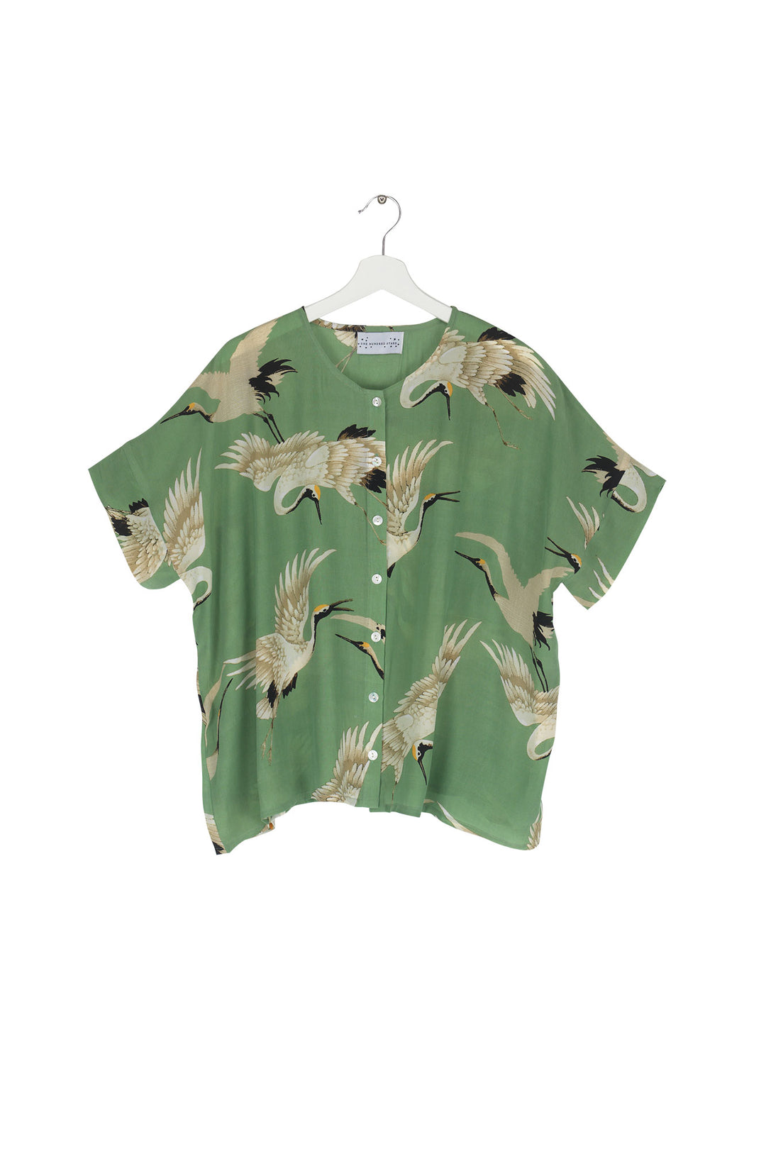 Women's short sleeve button up blouse in pea green and white stork print by One Hundred Stars