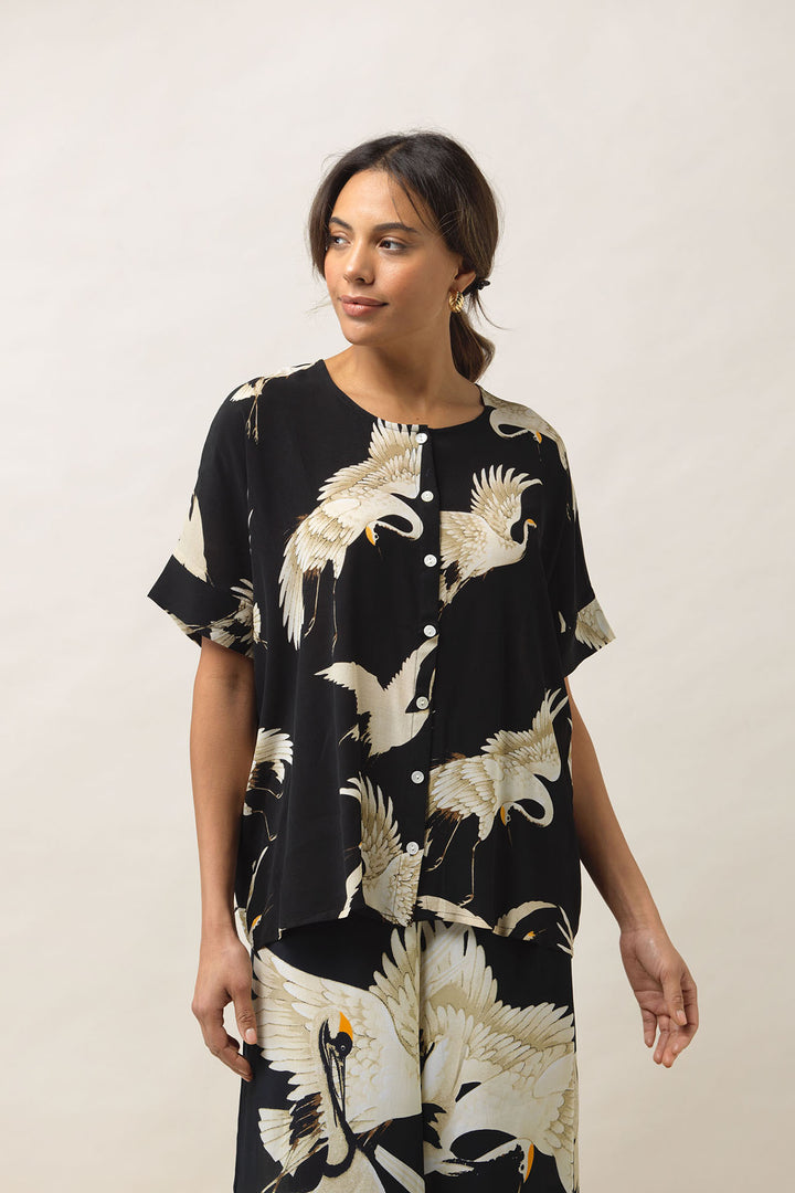 Women's short sleeve button up blouse in black and white stork print by One Hundred Stars