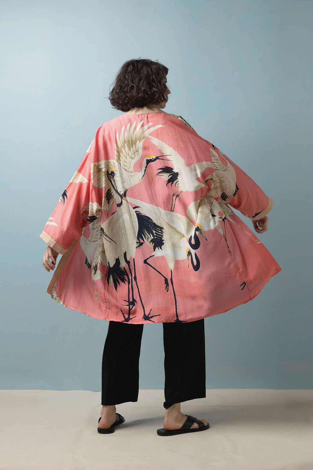 One Hundred Stars Stork Crane Lipstick Pink Collar mid length kimono, styled with black trousers and sandals. 