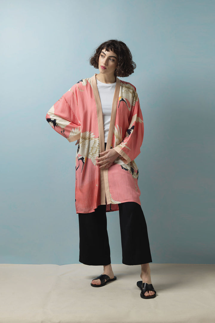 The One Hundred Stars Stork Crane Lipstick Pink Collar Kimono features white and black cranes on a vivid pink background with a contrasting dusty pink collar. 