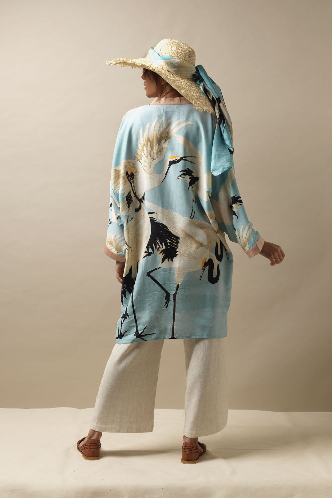 The One Hundred Stars Stork Sky Blue Collar Kimono is the perfect holiday cover up. adding a stylish twist to linen trousers and woven sandals. The Stork Sky Blue Scarf can also be tied around your hat to bring your whole outfit together. 